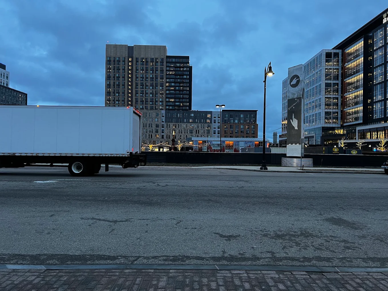 Dusk city street with parked white trailer