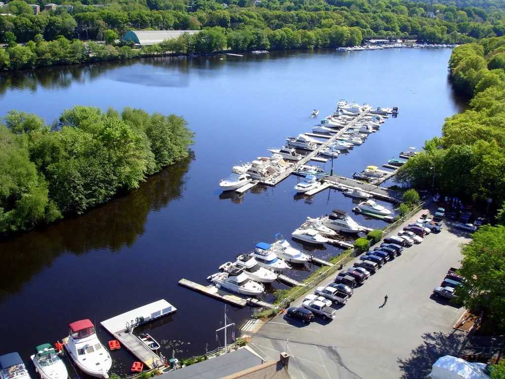 Aerial view of marina with boats and parking